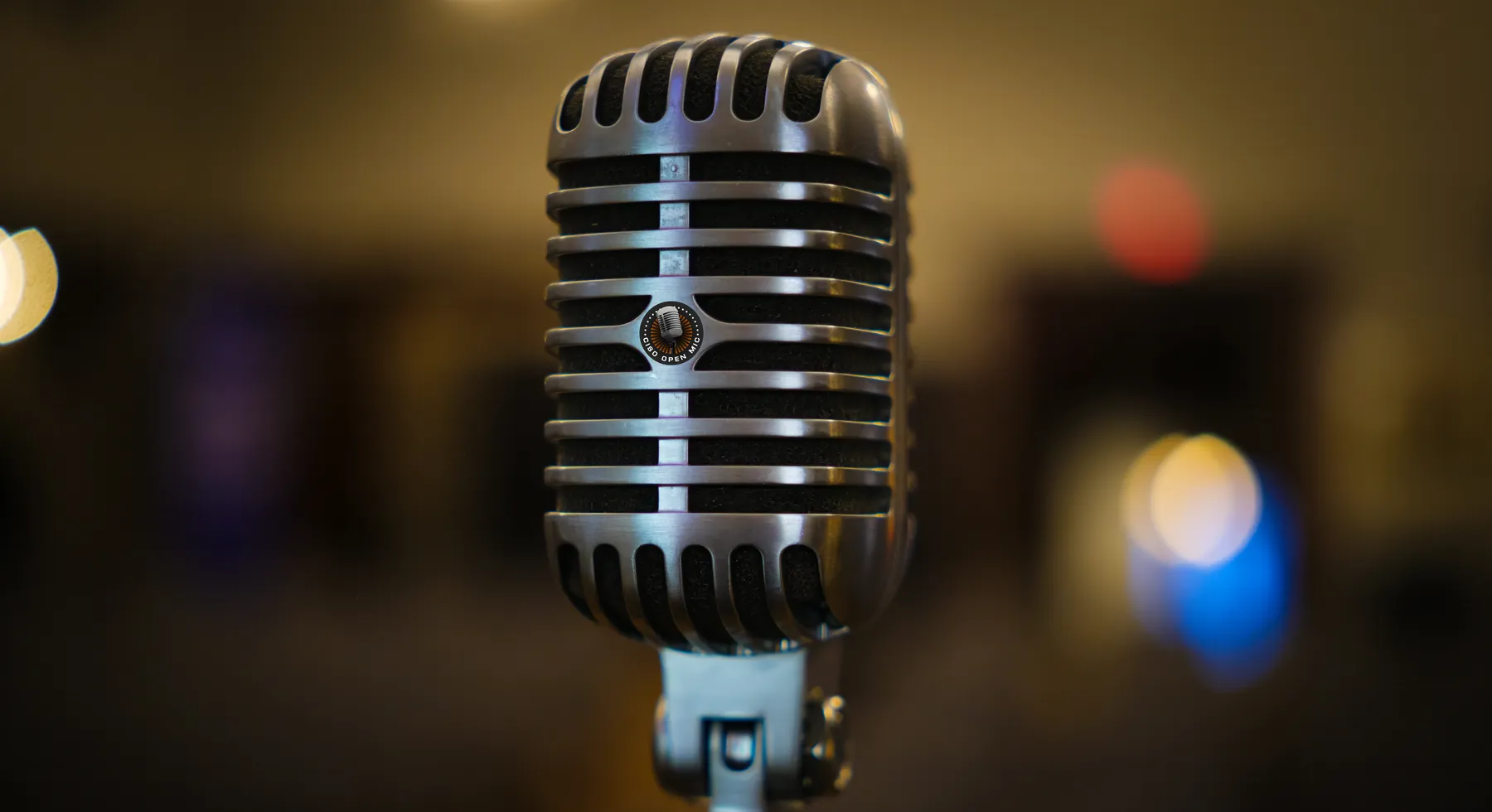 A vintage microphone bearing the CISO Open Mic logo
